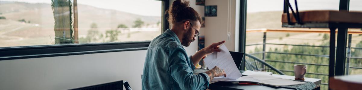Global employer reviewing papers on a desk.