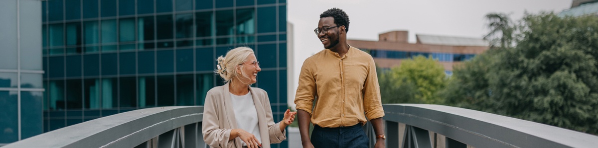 Man and woman talking outside of an office