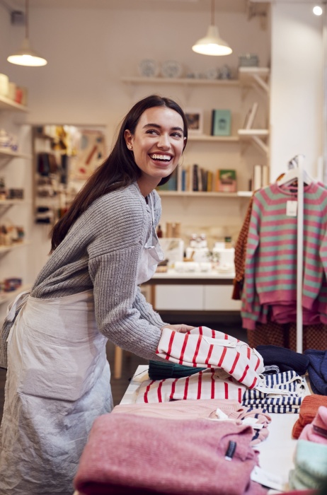 Boutique retail owner restocking store after using Pebl for EOR services.