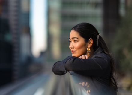 Woman looking out into a business district area