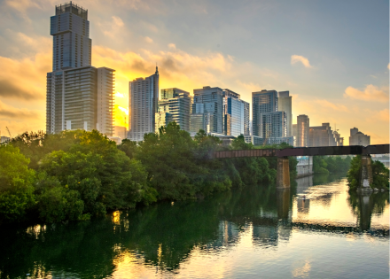 City skyline and river at sunset in the summer. 