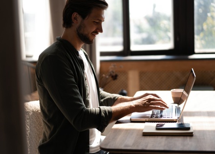 Man working remotely researching how to get a work visa for his employees