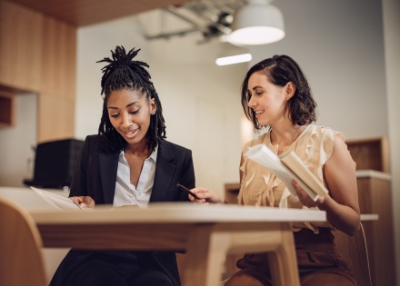 Two colleagues discuss their research on Philippines work visas