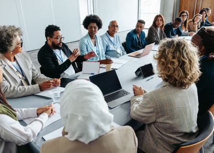 Conference room meeting discussing the impact of Trump's immigration
