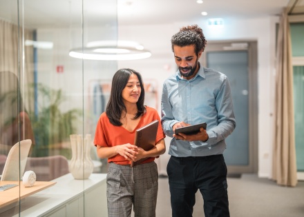 Coworkers walking and talking about global expansion challenges
