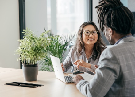 Colleagues discussing cross border mergers and acquisitions in an office