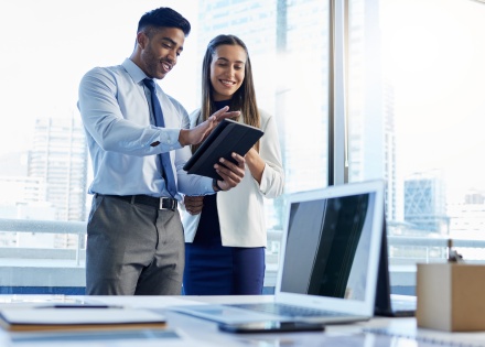 Colleagues compare the best crypto wallets on a tablet