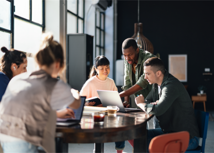 Team sitting at a table discussing employee benefits.