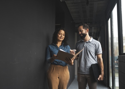 Global HR team members discussing how to hire AI engineers