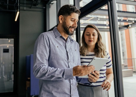 Woman and man looking at tablet
