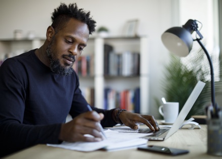 Man working in Alegria on laptop