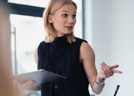 Professional woman in office setting providing HR strategy for hiring freezes.