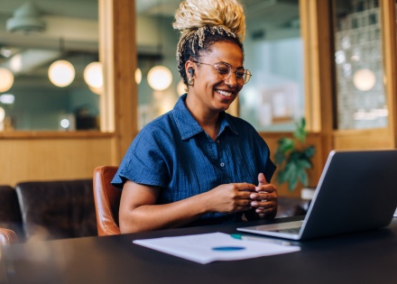 Smiling woman having a video call about salary in Bhutan