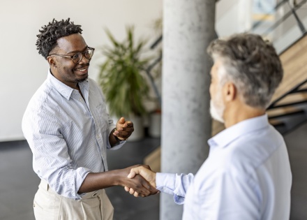 Two businessmen shaking hands in an office in Botswana