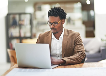 Young businessman working on his laptop at his home office in Cyprus