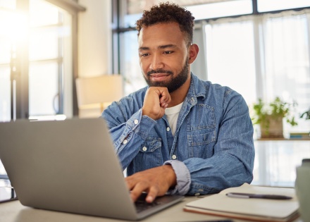 Businessman in Armenia reading an email on his laptop