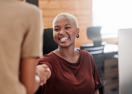Two businesswomen shaking hands after discussing salary in the Bahamas