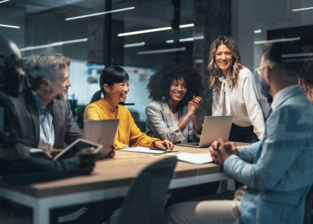 Colleagues discussing SMB growth strategy in modern conference room.