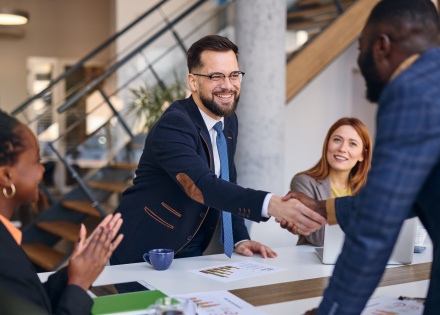 Business partner shaking hands after discussing salary in El Salvador