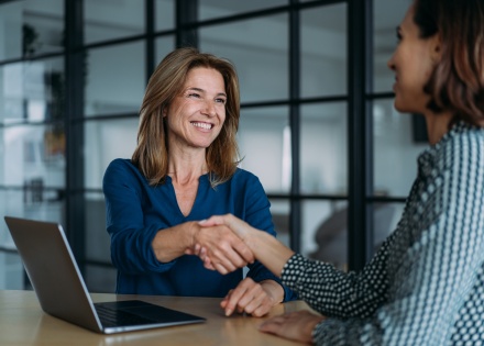 Businesswomen shaking hands in the office after discussing salary in Eswatini
