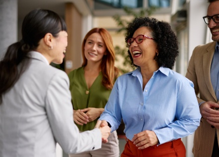 Diverse business colleagues shaking hands in a modern office