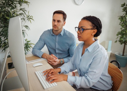 Global HR managers researching payroll tax in Uzbekistan together