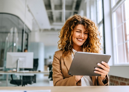 Young cheerful businesswoman working on a digital tablet in Turkmenistan