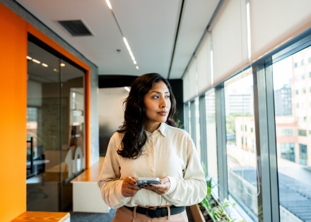 Young woman looking out the window in an office