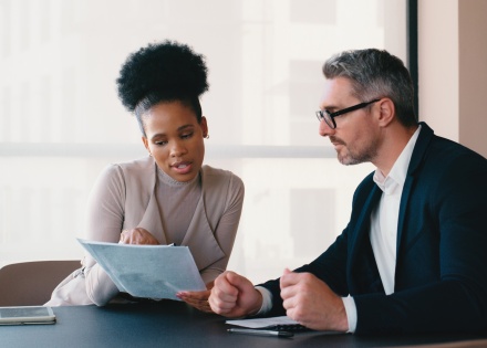 Two business people working on payroll taxes in Indonesia