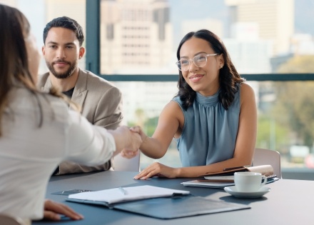Businesswoman shaking hands after discussing salary in Latin America