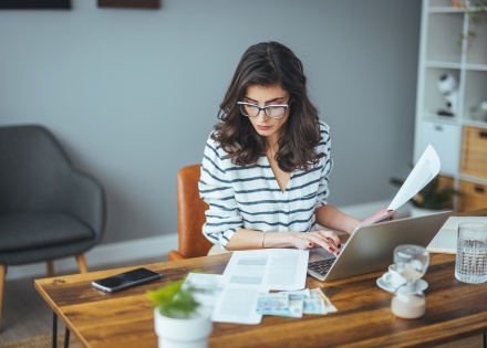 Businesswoman using a laptop to work on payroll taxes in the Czech Republic