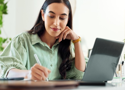 Woman working in home office with laptop