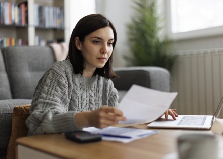 Young woman working on laptop in her living room in Kenya