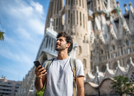 Adult male tourist with smartphone in Barcelona during a Spanish public holiday