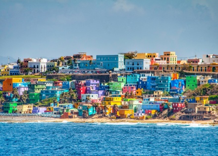 Bright colorful houses lining the hills overlooking the beach in San Juan, Puerto Rico