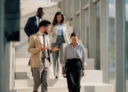 Businesspeople walking downstairs in modern office building