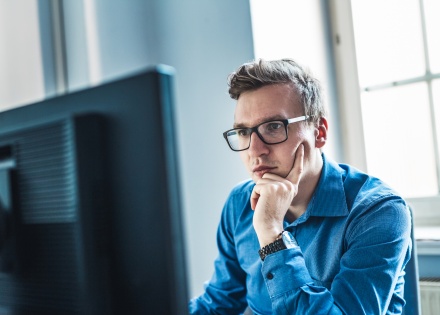 Businessman wearing eyeglasses sitting at his desk