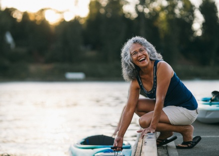 Cheerful senior woman preparing to kayak on a river during a public holiday in Suriname