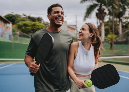 Couple smiling at a pickleball court enjoying Niger’s public holidays