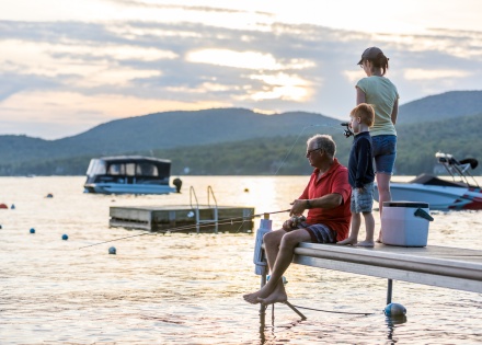 Family fishing at sunset during a summer public holiday in Estonia