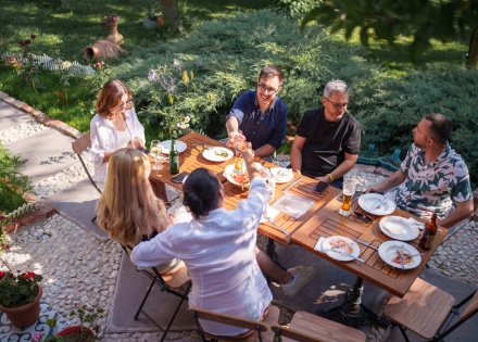 Friends enjoying an outdoor garden dinner together during a public holiday in Eswatini