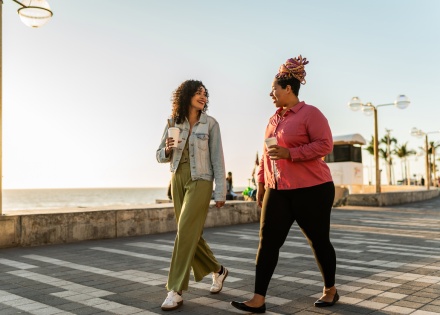 Friends walking along a beach during Angola’s public holidays