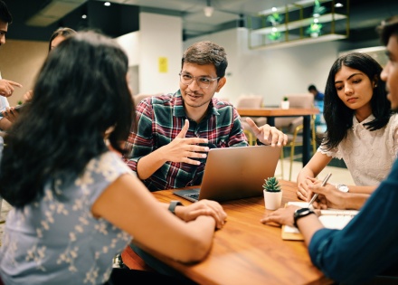 Global HR team discussing work culture in Oman in a meeting