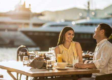 Happy couple sitting at a waterfront restaurant enjoying an Icelandic public holiday