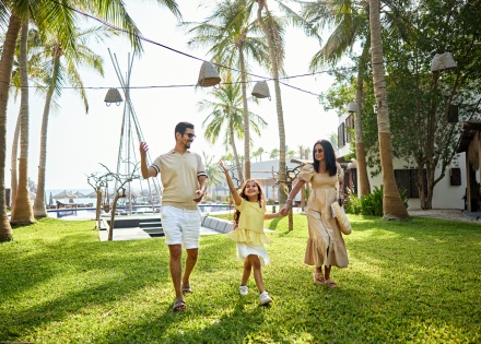Happy family enjoying a resort garden during a Guayana public holiday