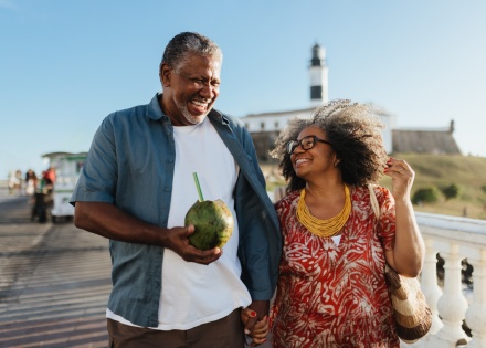 Happy senior couple enjoying a beach walk during a Dominican Republic public holiday