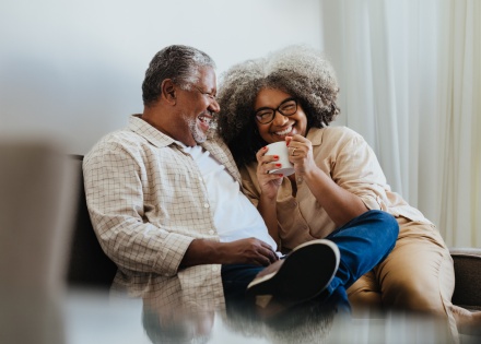 Happy senior couple enjoying coffee together at home during a Sierra Leone public holiday
