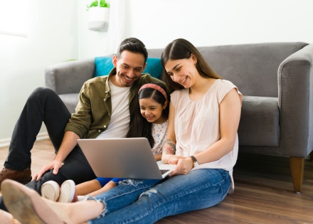 Family watching a movie on a laptop during Mexico’s public holidays