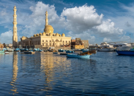 Hurghada mosque reflecting on the Red Sea with fishing boats