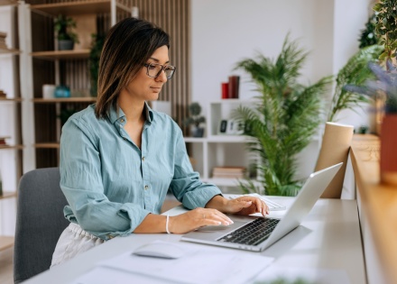 PPC manager working at a laptop in her home office